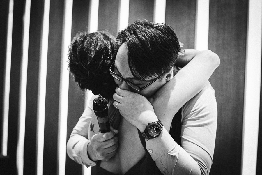groom having an emotional moment with his mother at uob plaza singapore wedding